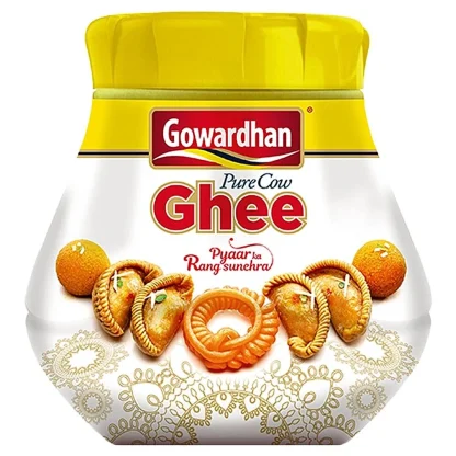 Golden, clarified ghee in a glass jar with a spoon, radiating rich aroma.