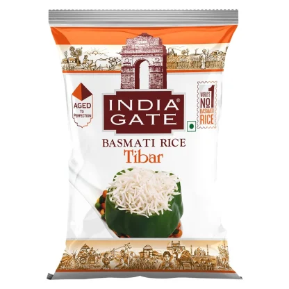Raw long-grain basmati rice in a bowl with a few grains scattered for texture.
