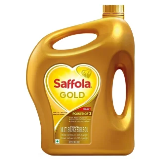 Bottle of blended cooking oil with healthy ingredients and vegetables in the background