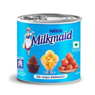 Sweetened condensed milk being poured into a glass bowl for baking.