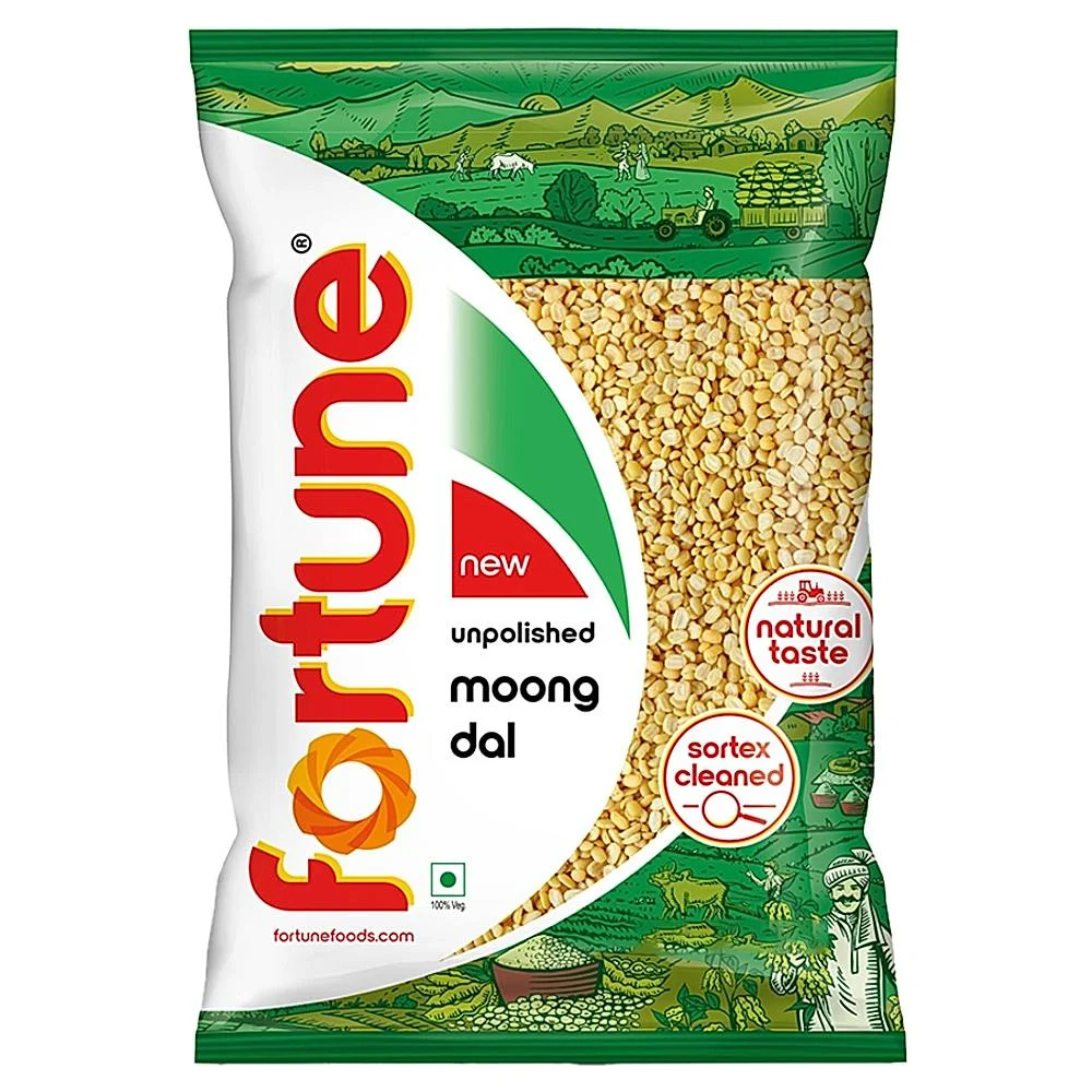 Moong lentils in a bowl including whole green moong and yellow split moong on a wooden surface