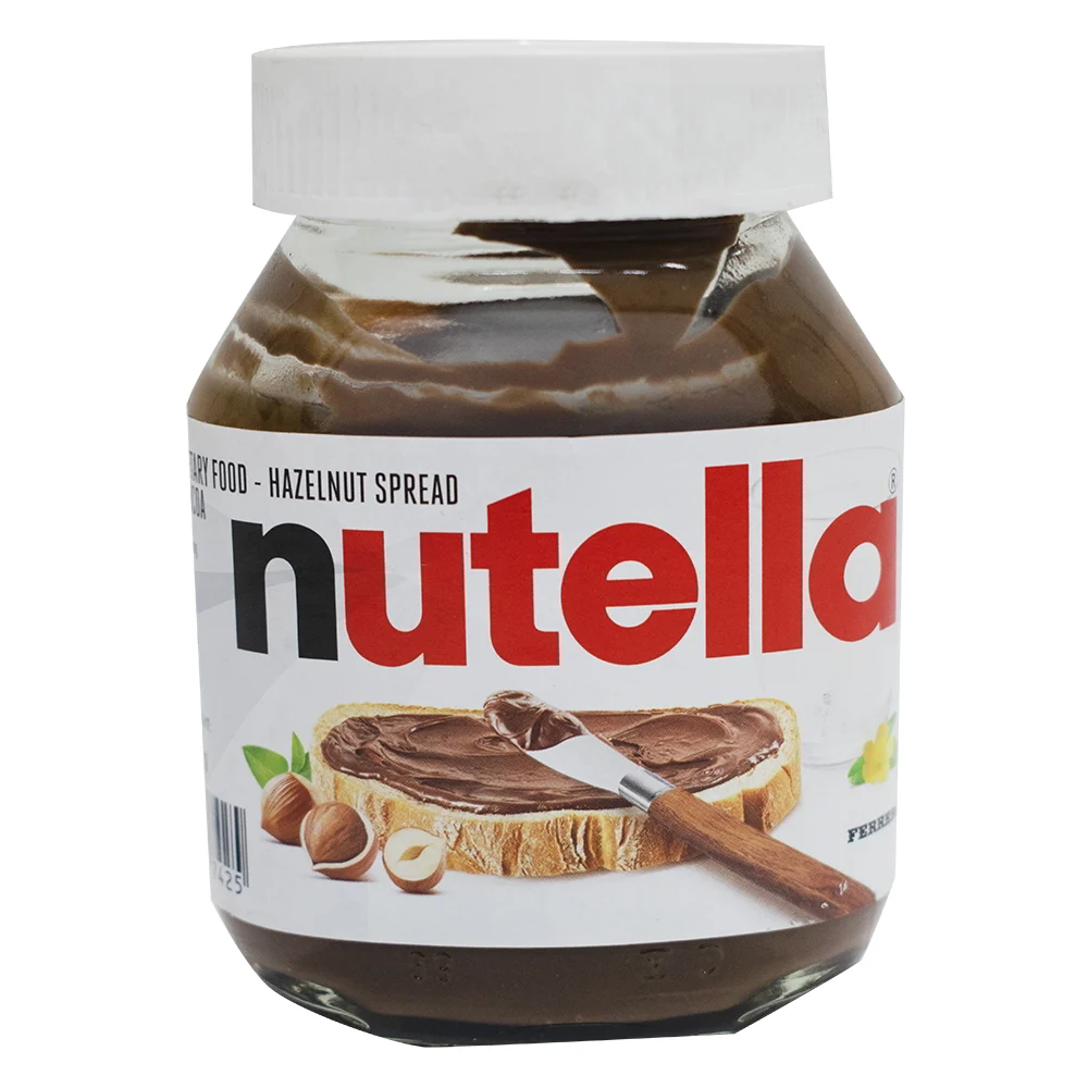 Assorted sweet and savory spreads in jars and tubs, including chocolate spread, peanut butter, and fruit spreads, arranged on a kitchen counter.