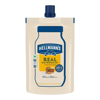 Jar of creamy mayonnaise with ingredients like eggs oil and lemon displayed on a kitchen counter